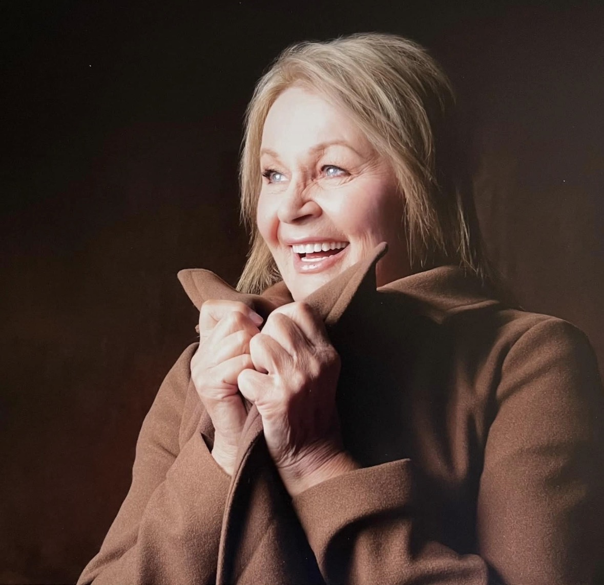 Older woman smiling comfortably at home, representing personalised support from Aurelia Community Services.